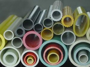 Assortment of colorful FRP round tubes in various sizes and thicknesses, showcasing different diameters and wall designs for industrial applications.