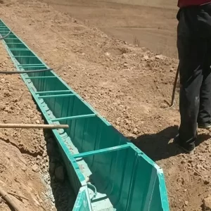 Green FRP drainage channel installed at outdoor construction site