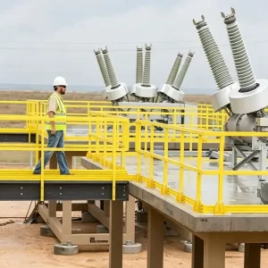 Yellow FRP grating walkway with safety railings in electrical substation