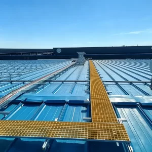 Brown molded FRP grating walkway installed on metal roof, fiberglass anti-slip grating for rooftop maintenance access, UV-resistant and lightweight