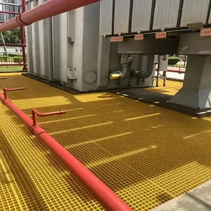 Brown molded FRP grating walkway installed on metal roof, fiberglass anti-slip grating for rooftop maintenance access, UV-resistant and lightweight