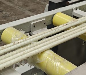 FRP rebar production process: raw material coils and finished product on manufacturing line