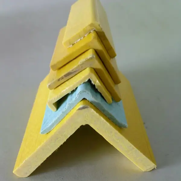 Stacked yellow fiberglass angle profiles, different sizes of FRP L-shaped structural bars