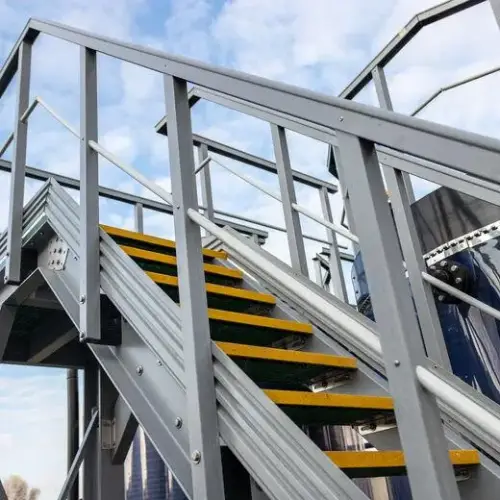 Industrial metal staircase with yellow FRP anti-slip nosing