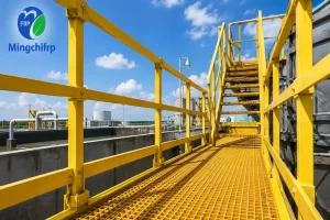 Outdoor FRP grating walkway and yellow fiberglass handrail system demonstrating weathering performance in industrial installations
