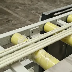 Finished GFRP rebar on conveyor rollers after production