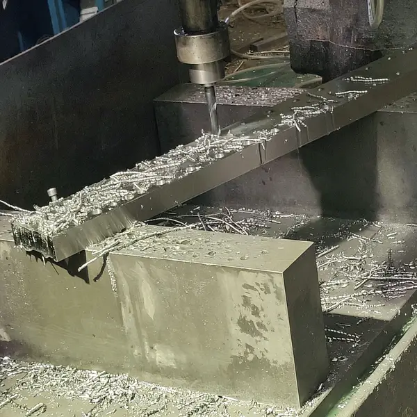 CNC drilling machine creating holes in FRP structural beams for assembly