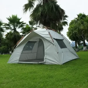 Large family camping tent set up on green grass with fiberglass support poles in outdoor park