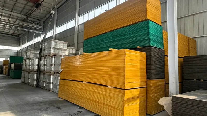 Multi-color bulk FRP fiberglass grating panels stacked in factory warehouse