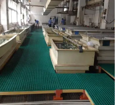 Green FRP grating flooring installed in a food processing facility