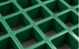 Close-up of green square mesh molded FRP grating