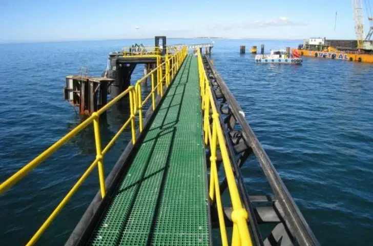 FRP grating walkway with yellow safety handrails on a marine dock