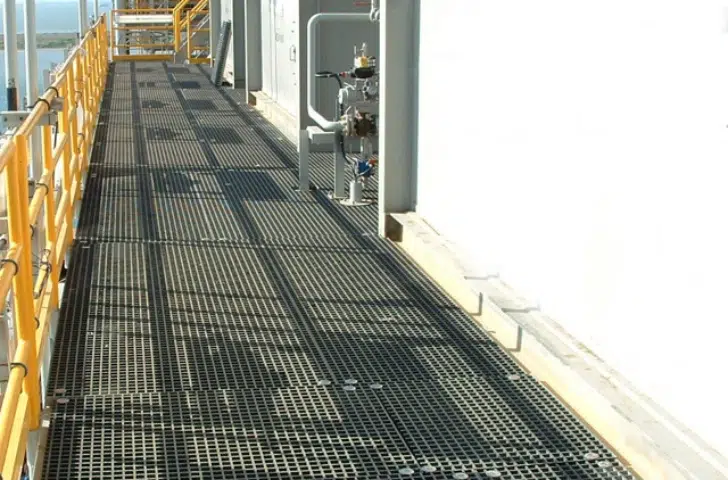 Gray FRP grating walkway with yellow safety handrails