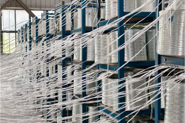 Stacks of white FRP pultruded profiles in the Mingchi factory