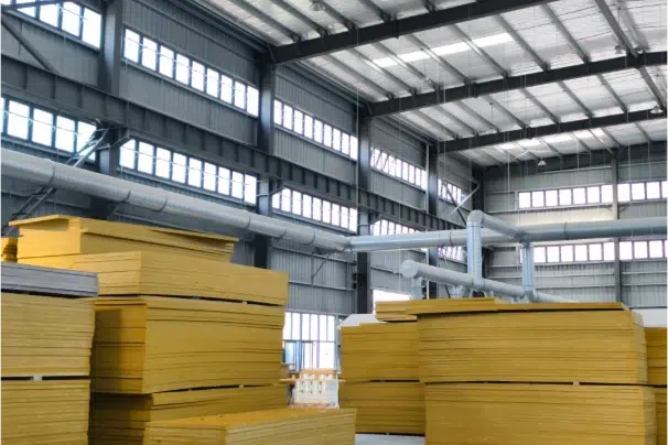 Stacks of yellow molded FRP grating panels in the Mingchi factory